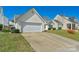 Exterior image features an attached garage, paved driveway, and well-maintained lawn at 6821 Parkers Crossing Dr, Charlotte, NC 28215