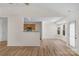 Open-concept living space with hardwood floors, a view of the kitchen, and natural light at 6821 Parkers Crossing Dr, Charlotte, NC 28215
