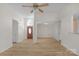 Spacious living room featuring light wood floors and a ceiling fan at 6821 Parkers Crossing Dr, Charlotte, NC 28215