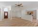 Spacious living area with wood floors, a kitchen view, and lots of natural light at 6821 Parkers Crossing Dr, Charlotte, NC 28215