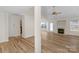 Light-filled living room features a cozy fireplace, wood floors, and an open floor plan at 6821 Parkers Crossing Dr, Charlotte, NC 28215