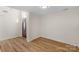 Bright living room with light wood floors and entrance door at 6821 Parkers Crossing Dr, Charlotte, NC 28215