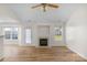 Cozy living room featuring a fireplace, hardwood floors, and a bright, airy atmosphere at 6821 Parkers Crossing Dr, Charlotte, NC 28215