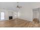 Comfortable living room with a fireplace and light wood floors at 6821 Parkers Crossing Dr, Charlotte, NC 28215