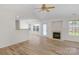 Bright living room with fireplace, hardwood floors, and abundant natural light at 6821 Parkers Crossing Dr, Charlotte, NC 28215