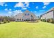 Expansive backyard featuring a patio area, lush green lawn, and privacy fencing at 7313 Glenroe Dr, Huntersville, NC 28078