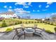Spacious backyard features a fire pit with seating, lush lawn, and mature landscaping at 7313 Glenroe Dr, Huntersville, NC 28078