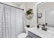 Modern bathroom showcasing sleek fixtures, and a decorative shower curtain at 7313 Glenroe Dr, Huntersville, NC 28078