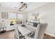 Dining room with a long white table, modern chandelier, and large window at 7313 Glenroe Dr, Huntersville, NC 28078