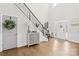 Grand foyer with hardwood floors, a staircase with iron railings, and decorative accents at 7313 Glenroe Dr, Huntersville, NC 28078