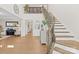 Inviting foyer featuring hardwood floors, a staircase with iron railings, and an open floor plan at 7313 Glenroe Dr, Huntersville, NC 28078