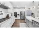 A modern kitchen features a gas range, stainless appliances, and white cabinetry at 7313 Glenroe Dr, Huntersville, NC 28078
