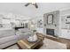 Bright living room boasts a stone fireplace, hardwood floors, and seamless flow to the kitchen at 7313 Glenroe Dr, Huntersville, NC 28078