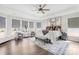 Expansive main bedroom with tray ceilings, large windows, and cozy seating area at 7313 Glenroe Dr, Huntersville, NC 28078