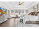 An airy main bedroom has a tray ceiling, sitting area, and large windows at 7313 Glenroe Dr, Huntersville, NC 28078