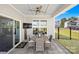 Covered outdoor patio featuring a dining table, ceiling fan, and access to a well-maintained yard at 7313 Glenroe Dr, Huntersville, NC 28078