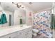 Bright bathroom with a large mirror and a floral shower curtain at 816 Gentlewinds Ct, Fort Mill, SC 29708