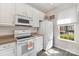 Bright kitchen features white cabinetry, modern appliances, and a window providing natural light at 816 Gentlewinds Ct, Fort Mill, SC 29708