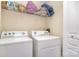 Laundry room with washer, dryer, and storage shelf at 816 Gentlewinds Ct, Fort Mill, SC 29708