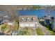 Aerial view of a lakeside home featuring a three-car garage and well maintained lawn at 938 Pinehaven Dr, New London, NC 28127