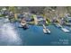 Stunning aerial view of waterfront homes with private docks and boat lifts on a serene lake at 938 Pinehaven Dr, New London, NC 28127