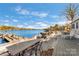 Lakefront back deck with grill, dining table, and seating for enjoying outdoor meals with a view at 938 Pinehaven Dr, New London, NC 28127
