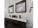 Bathroom featuring a double vanity with dark wood cabinets and modern fixtures at 938 Pinehaven Dr, New London, NC 28127