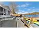 Lake house deck featuring a grill, kayaks, and comfortable seating with views of the water at 938 Pinehaven Dr, New London, NC 28127