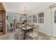 Charming dining room with a rustic table, chair set, and ample natural light overlooking the water at 938 Pinehaven Dr, New London, NC 28127