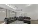 Garage transformed into a living area featuring comfortable sofas and concrete floors at 938 Pinehaven Dr, New London, NC 28127
