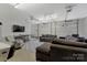 Spacious garage converted into a living area featuring comfortable sofas and a TV at 938 Pinehaven Dr, New London, NC 28127