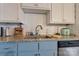 Close-up of the kitchen sink and countertop featuring granite counters and white subway tile at 938 Pinehaven Dr, New London, NC 28127