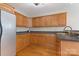 Efficient kitchen featuring wood cabinetry, stainless sink, and hardwood flooring at 938 Pinehaven Dr, New London, NC 28127