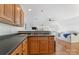 A cozy kitchenette with wood cabinets and a dark countertop at 938 Pinehaven Dr, New London, NC 28127