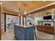 Open floor plan featuring a kitchen island with seating flowing into the living room and dining area at 938 Pinehaven Dr, New London, NC 28127