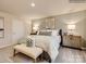 Tastefully designed main bedroom with neutral colors, bench seat, and coordinated furnishings at 10014 Chatham Run Ln, Charlotte, NC 28262