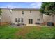 Large backyard featuring a well maintained lawn, patio area and privacy fence at 10241 Barrands Ln, Charlotte, NC 28278
