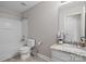 Bright bathroom featuring a marble countertop vanity with a sink, a mirror and a bathtub at 10241 Barrands Ln, Charlotte, NC 28278