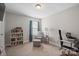 Cozy bedroom with a window, carpet flooring, a bookcase, desk and a chair at 10241 Barrands Ln, Charlotte, NC 28278