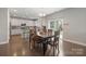 Dining area connected to kitchen, featuring hardwood floors and sliding glass doors to the outdoor space at 10241 Barrands Ln, Charlotte, NC 28278