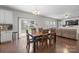 Open dining area with dark wood floors, a large table with seating for six, and sliding glass door to outside at 10241 Barrands Ln, Charlotte, NC 28278