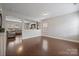 Spacious living room with hardwood floors, adjacent to a comfortable seating area and great natural light at 10241 Barrands Ln, Charlotte, NC 28278