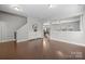 Open-concept living area boasts hardwood floors and neutral paint, perfect for entertaining and relaxation at 10241 Barrands Ln, Charlotte, NC 28278