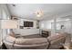 Relaxing living room featuring sectional seating, a custom media center, and an open layout for seamless entertaining at 10241 Barrands Ln, Charlotte, NC 28278