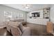 Comfortable living room features a large sectional sofa and a custom built-in entertainment center with shelving at 10241 Barrands Ln, Charlotte, NC 28278