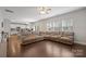 Open floor plan merges living area and kitchen with hardwood floors, offering ample seating and bright lighting at 10241 Barrands Ln, Charlotte, NC 28278