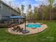 Backyard features a lovely pool, patio with an umbrella and an outdoor dining space, perfect for entertaining and relaxation at 1041 Crofton Dr, Waxhaw, NC 28173