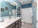 Bathroom featuring a double sink vanity and a tiled shower at 1041 Crofton Dr, Waxhaw, NC 28173