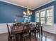 Classic dining room featuring dark wood floors, a large window, and a stylish chandelier over a dining table at 1041 Crofton Dr, Waxhaw, NC 28173