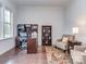 Bright home office features a desk, shelving, and a comfortable sitting area at 1041 Crofton Dr, Waxhaw, NC 28173